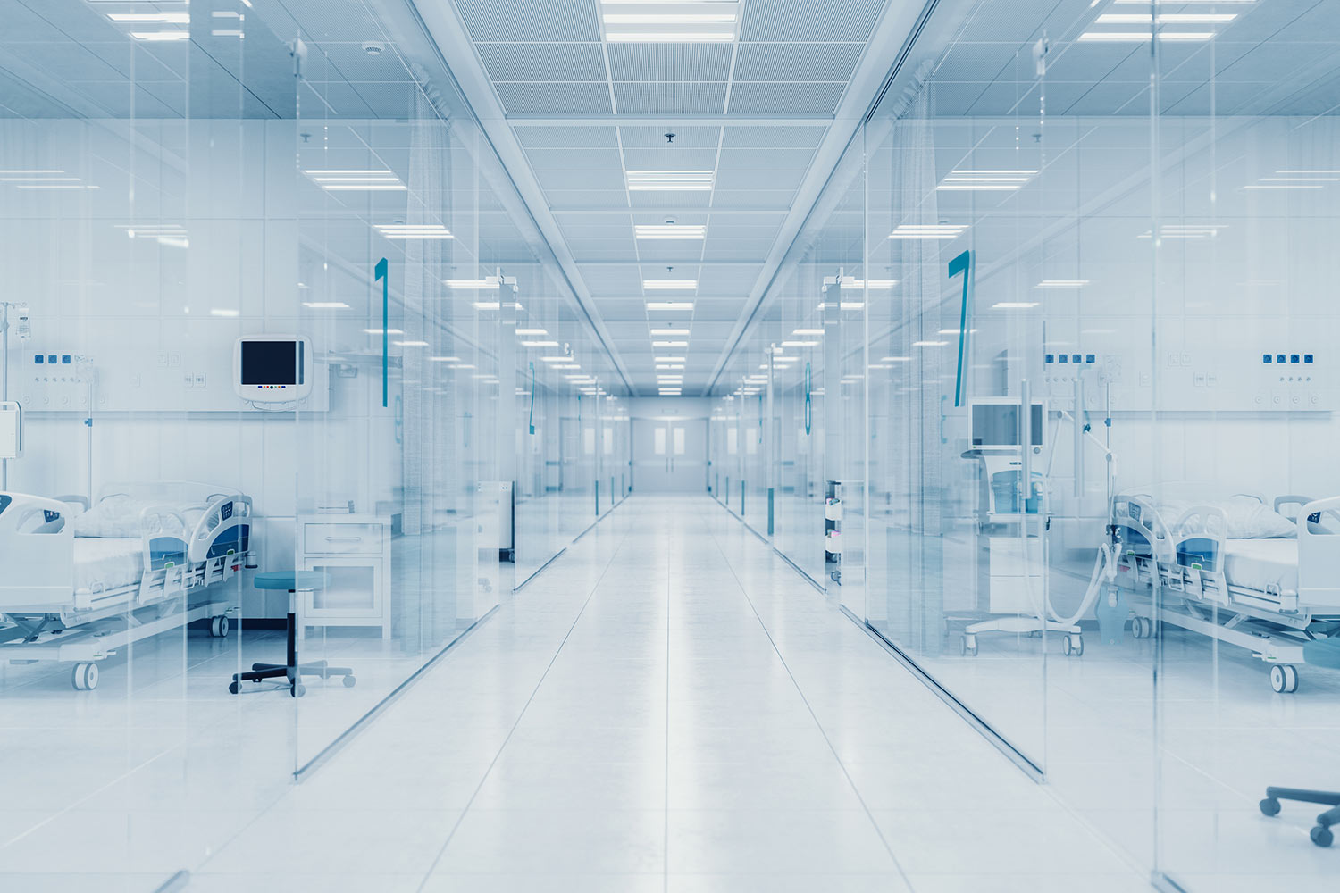 Hospital corridor with connected bedside monitors and clinical equipment