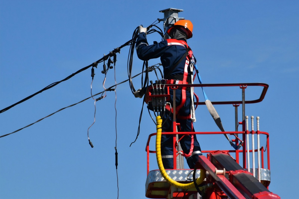 Utility worker servicing power infrastructure