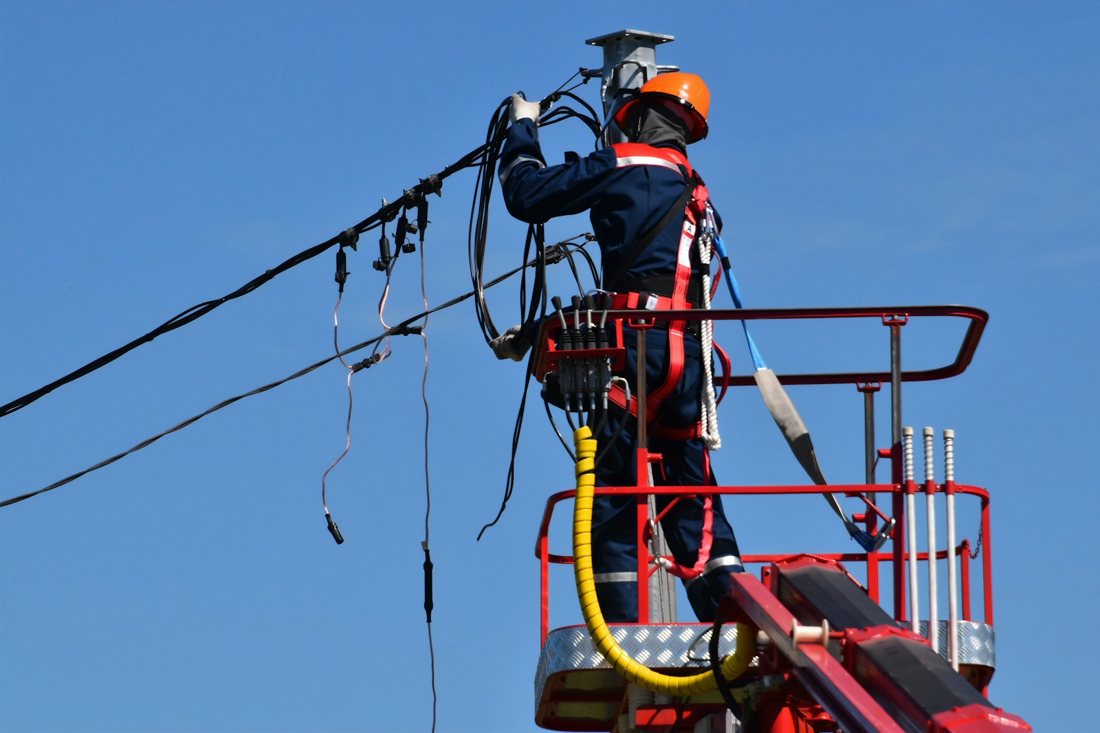 Utility lineworker repairing overhead electrical equipment